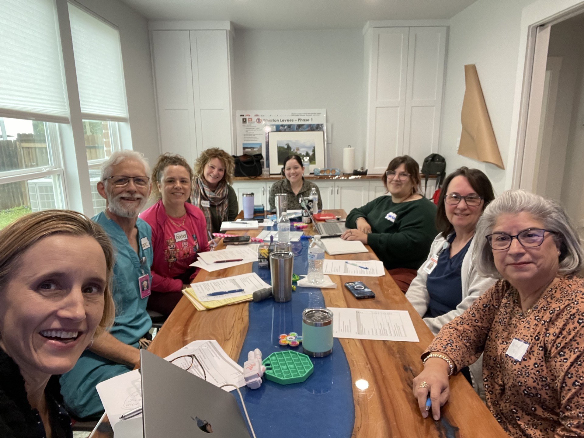 Cathy Doggett leading a meeting around a table